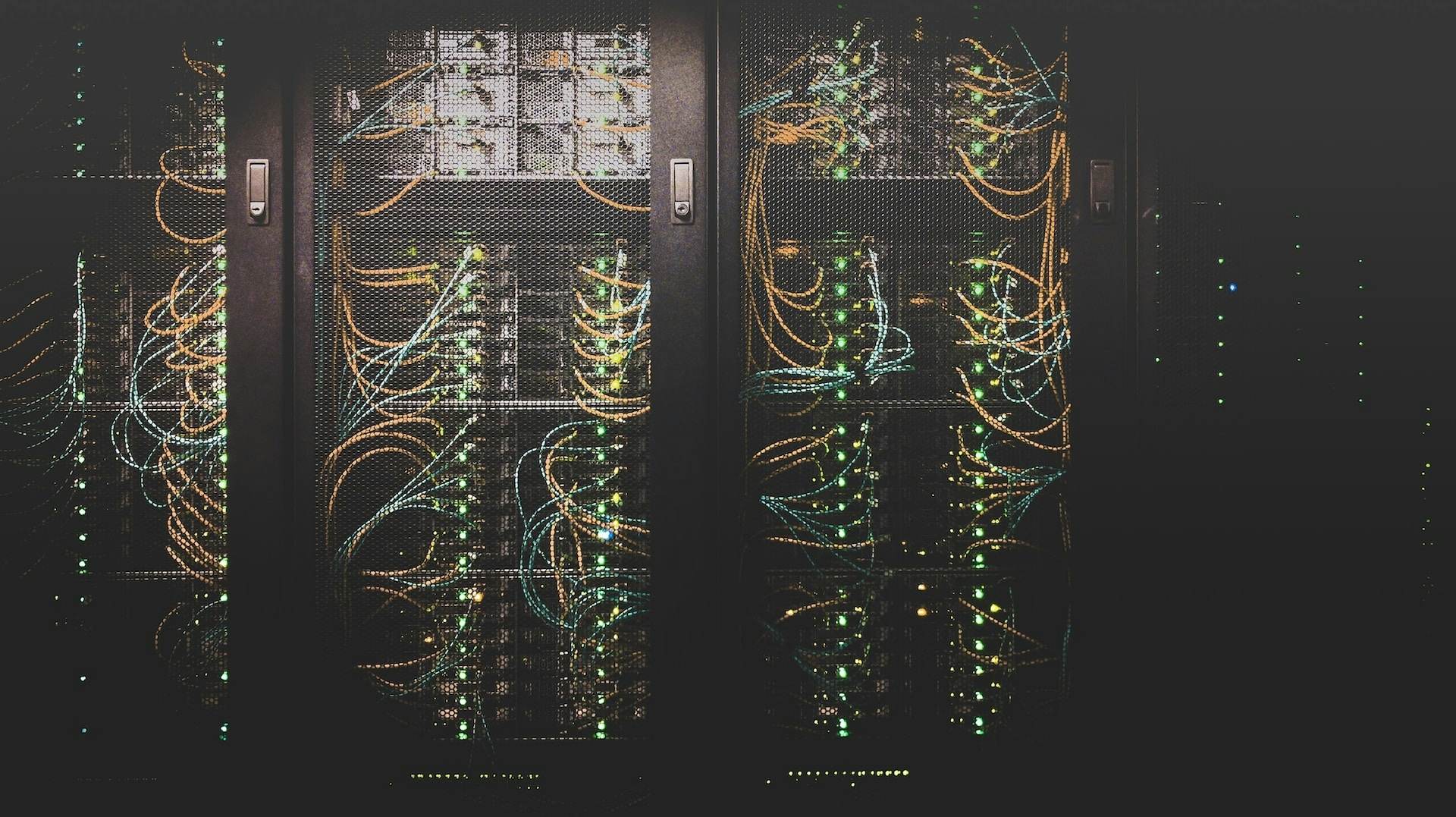 An image of multiple servers in a dark room.